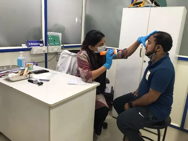 Excell ENT Clinic doctor examining a patient at a free health camp